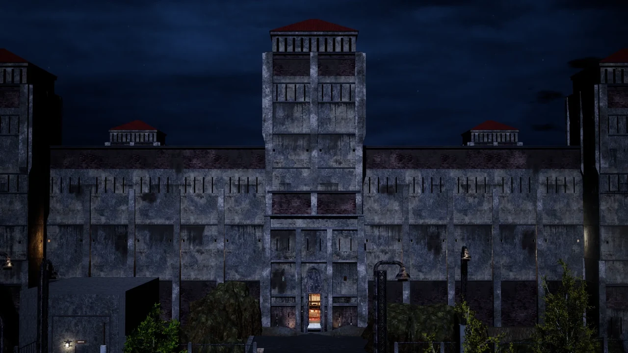 The current prison entrance and central tower at night, with moving cloud cover above the stone façade.